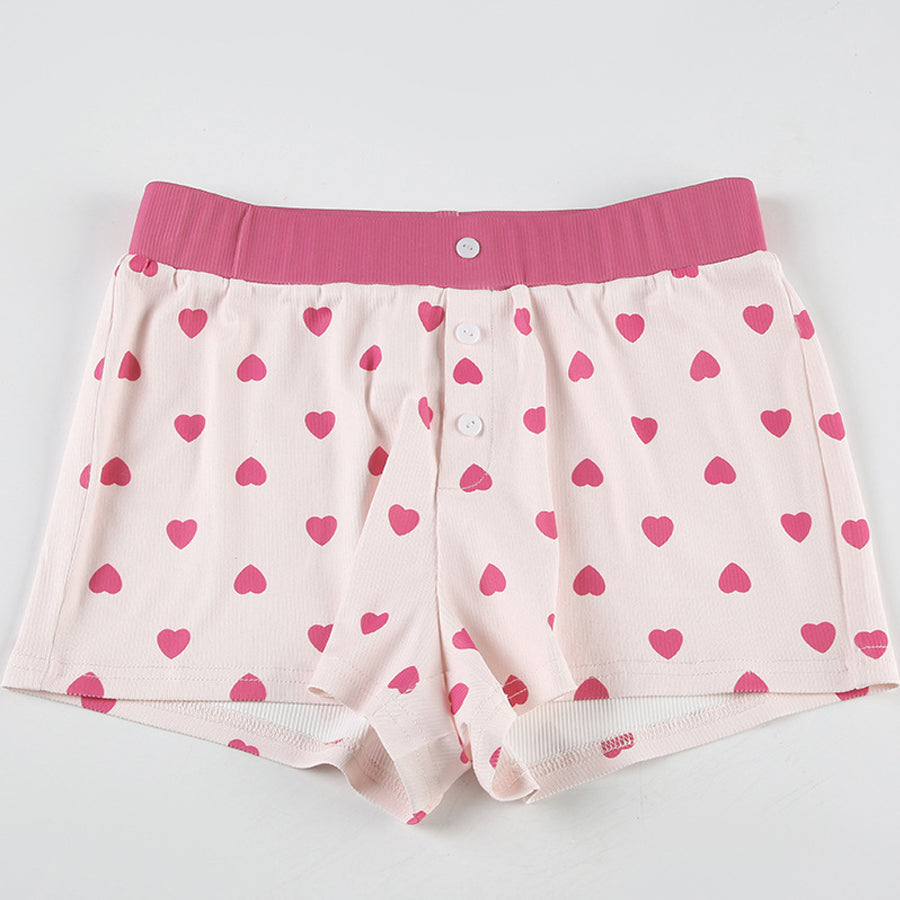 Close-up of the lettuce-edge hem and rib-knit texture of the Costume Inspire heart print pajama top, focusing on the soft pink fabric and red hearts.