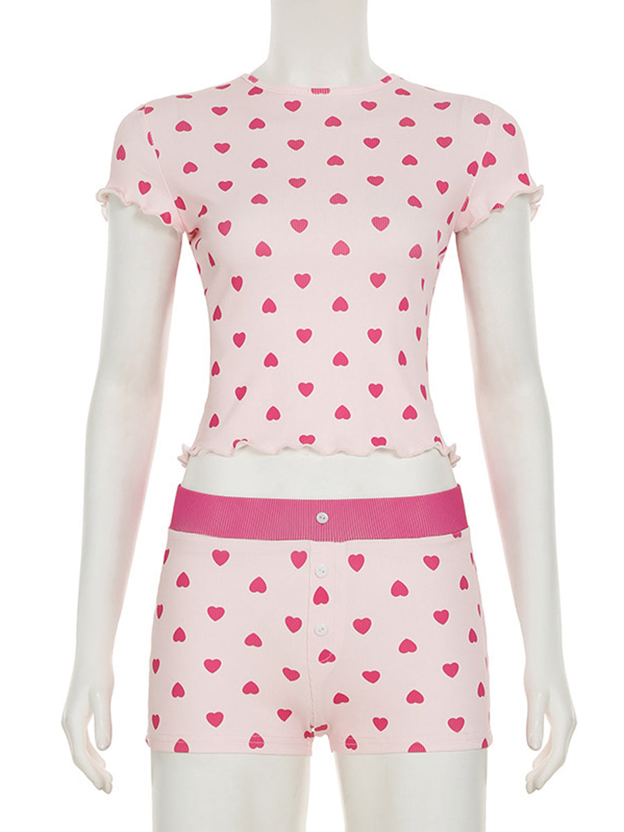 Front view of the All My Love 2-piece pajama set on a mannequin, highlighting the red heart pattern and lettuce-edge trim details on the pink ribbed fabric.