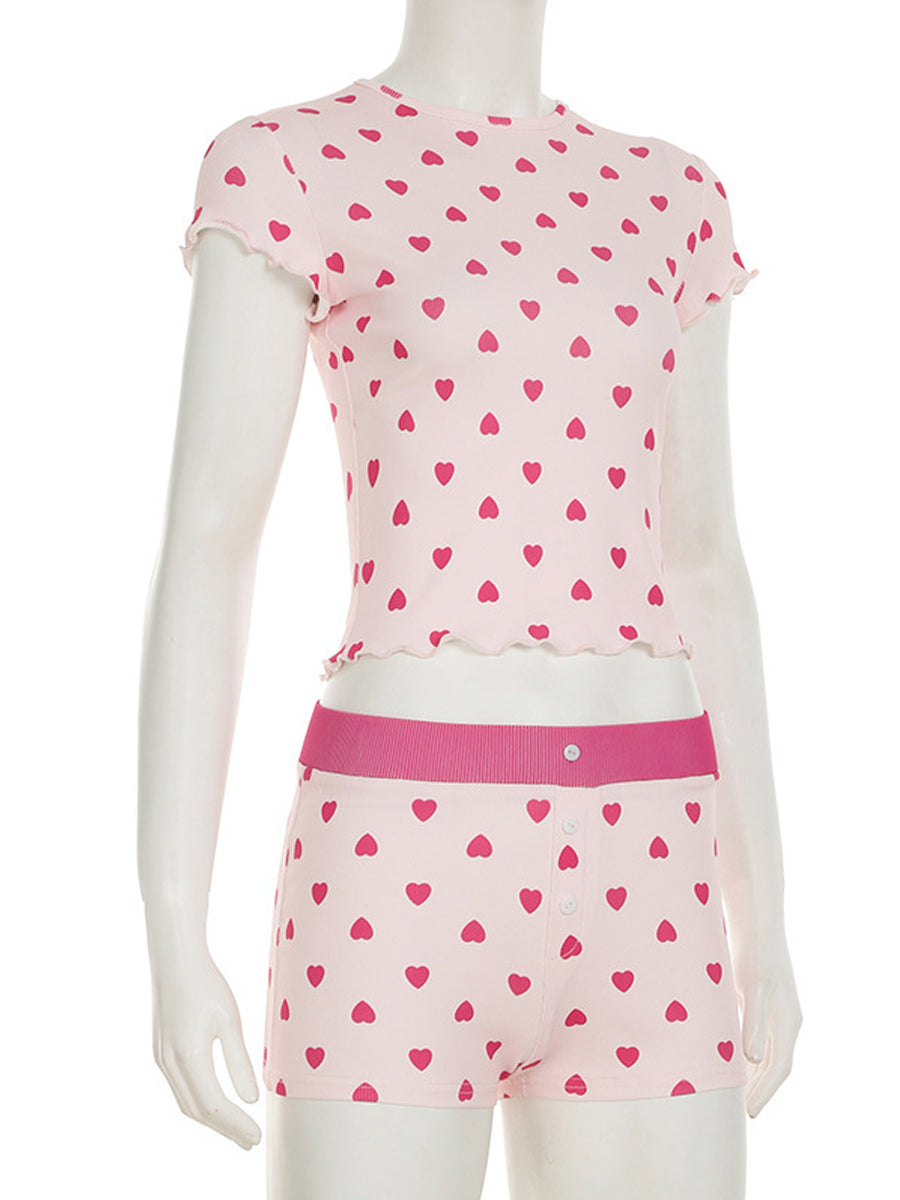 Front view of the All My Love 2-piece pajama set on a mannequin, highlighting the red heart pattern and lettuce-edge trim details on the pink ribbed fabric.