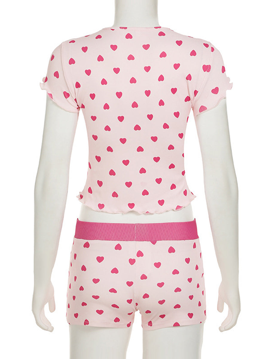 Back view of the All My Love 2-piece pajama set on a mannequin, highlighting the red heart pattern and lettuce-edge trim details on the pink ribbed fabric.