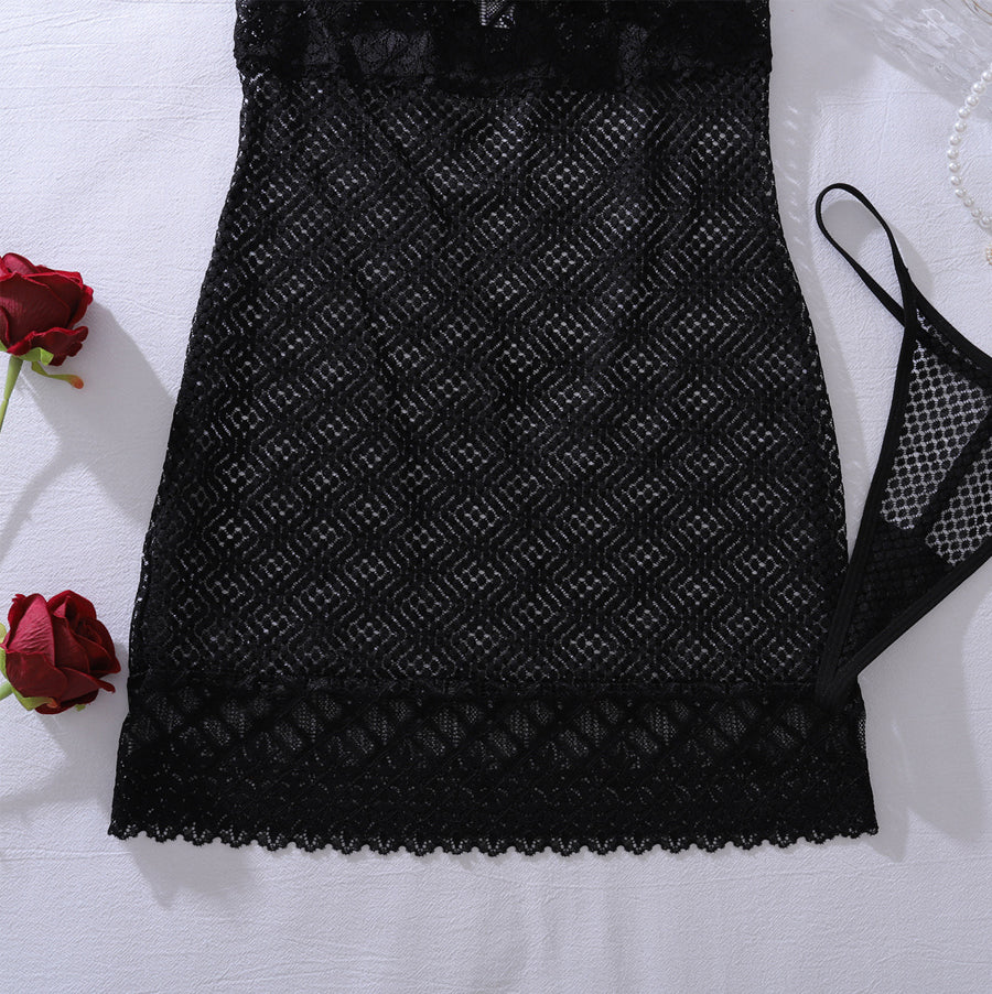 Close-up detail of sheer diamond net mesh fabric and intricate floral lace trim on a sexy black mini dress.