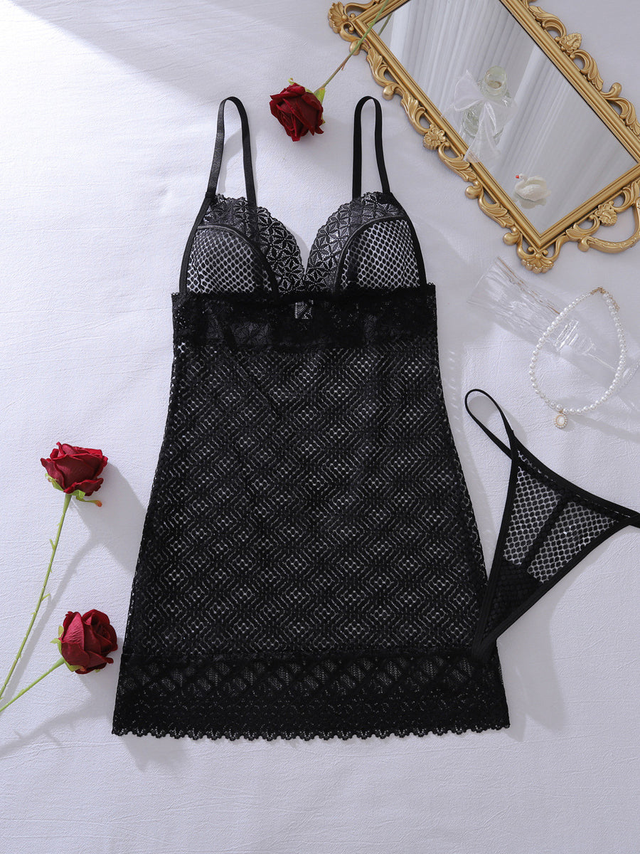 Close-up detail of sheer diamond net mesh fabric and intricate floral lace trim on a sexy black mini dress.
